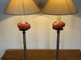 two lamps that are on a table with a lamp on it