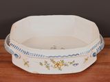a white bowl with blue and yellow flowers on it