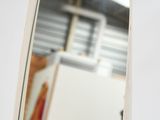 a mirror that is hanging on a wall in a room