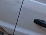 a close up of a car door handle with a reflection on the door