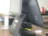 an image of a desk with a monitor, keyboard, and remote control