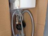 a picture of a box with a hose and a water heater in it