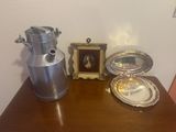 a silver vase and a silver tray on a wooden table