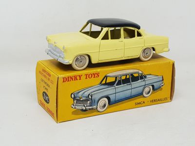 a yellow toy car sitting on top of a yellow box