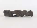 a close up of a figurine of a fish on a white surface