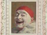 tableau représentant un enfant qui rit, coiffé d'un bonnet rouge, dans un cadre blanc