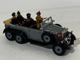 a toy car with three men in it on a white surface