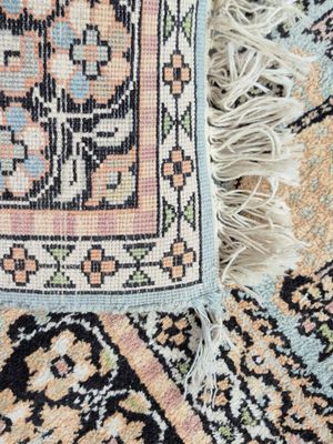 an image of a close up of a rug with fringes on it