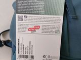 a tag on the back of a backpack that is attached to it