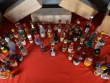 many bottles of alcohol sitting on a red table cloth