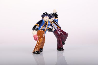 a figurine of a man and a woman holding hands