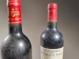two bottles of wine sitting next to each other on a table