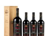 three bottles of red wine in a wooden case with a wooden box