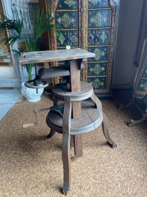 a wooden table with a potted plant on top of it