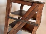 a wooden chair that is sitting on a white surface