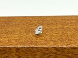 a small diamond sitting on top of a wooden box