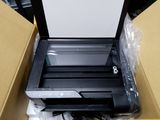 a printer sitting inside of a box on a table
