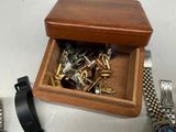 a wooden box with a bunch of watches inside of it
