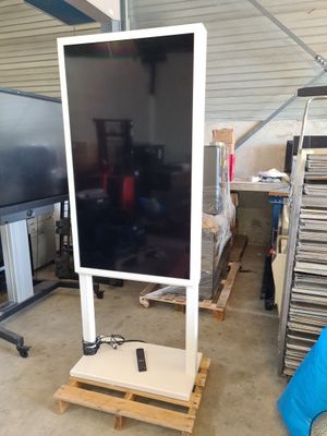 a television on a stand in a garage