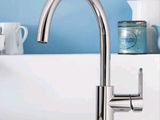 a kitchen sink with a faucet and dishes on the counter