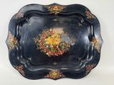 a black tray with a floral design on it
