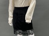 an image of a mannequin wearing a white blouse and black skirt