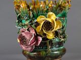 a vase that has flowers in it on a stand