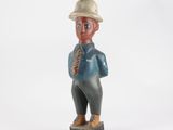 une image représentant une figurine d'un homme portant un chapeau et une cravate