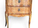 an old wooden chest of drawers with a marble top