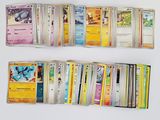 a lot of pokemon cards on a white table