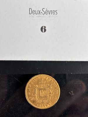 a close up of a gold coin in a box on a table