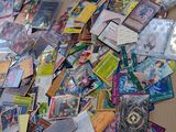 a pile of cards on the floor next to a laptop