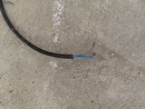 a black and blue hose on the ground next to a black and blue hose