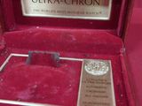 a red box with a silver medal in it on a table