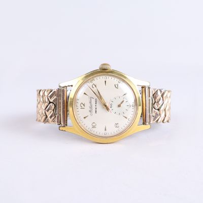 une image représentant une montre en or et en argent avec un cadran blanc