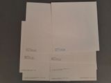 three sheets of white paper are stacked on top of each other