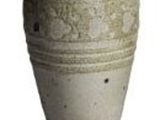 une image représentant un vase posé sur une surface blanche