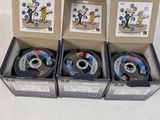 four spools of spools of various sizes and colors in a box