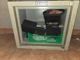 a small safe box with a bunch of items inside of it