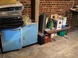 a room with a stove, refrigerator, and other items in it