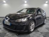 the black volkswagen golf is parked on a checkered tile floor