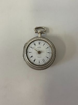 une montre de poche en argent avec des chiffres romains sur le cadran