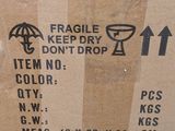 a cardboard box with a sign on it that says fragile keep dry don ' t drop