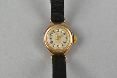 an image of a gold watch with a black strap
