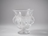 a clear glass vase with a flower design on it