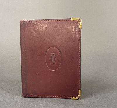 a brown leather wallet sitting on top of a gray surface