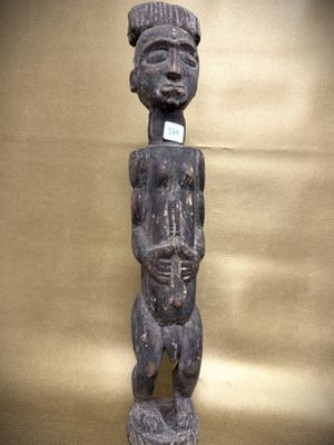 an old wooden statue of a man holding a baby in his arms