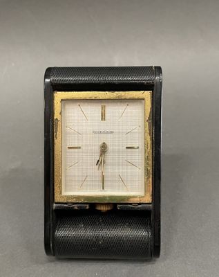 an image of a black and gold clock on a table
