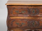an old wooden chest of drawers with ornate carvings on the drawers