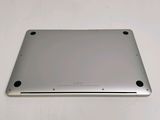 the back side of a silver laptop with a small hole in the middle of it